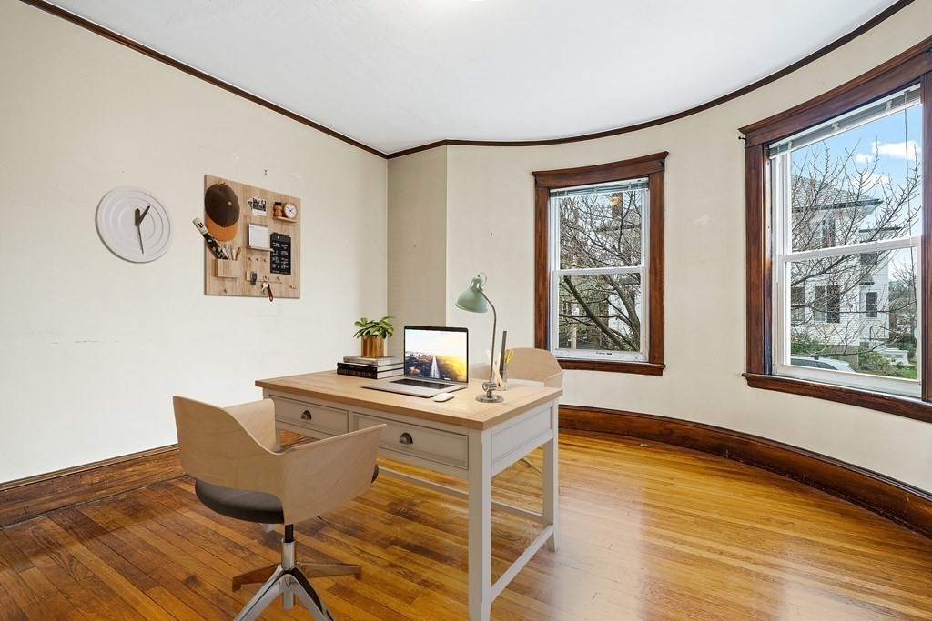73 Halifax Street Boston, MA 02130 - Photo 4 of 18 a view of a workspace with furniture and a window
