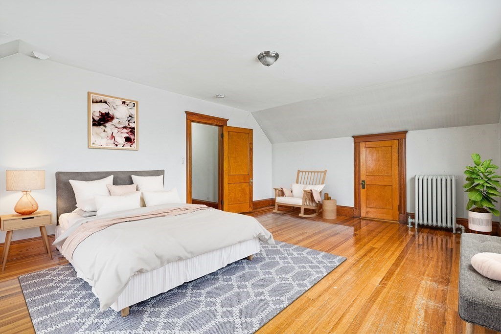 73 Halifax Street Boston, MA 02130 - Photo 7 of 18 a bedroom with a bed and wooden floor