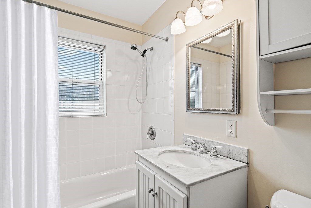 73 Halifax Street Boston, MA 02130 - Photo 9 of 18 a bathroom with a granite countertop sink toilet and shower