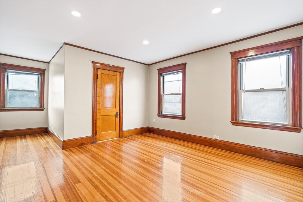 73 Halifax Street Boston, MA 02130 - Photo 10 of 18 wooden floor in an empty room with a window