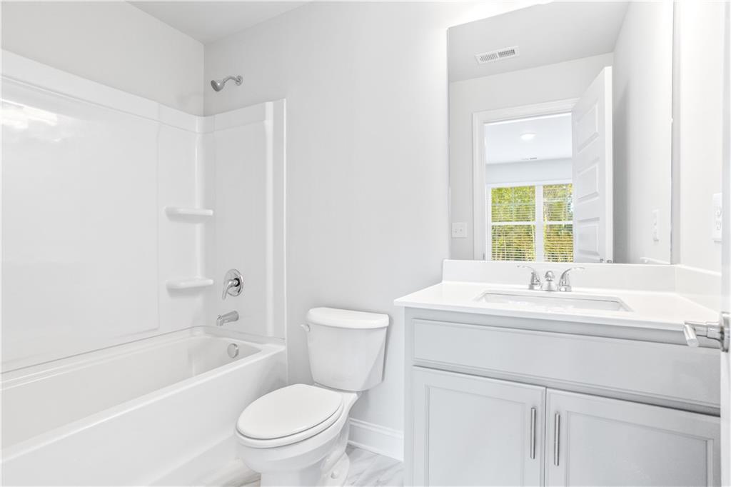 70 Cooper Drive Mansfield, GA 30055 - Photo 13 of 32 a bathroom with a sink a toilet and a bathtub