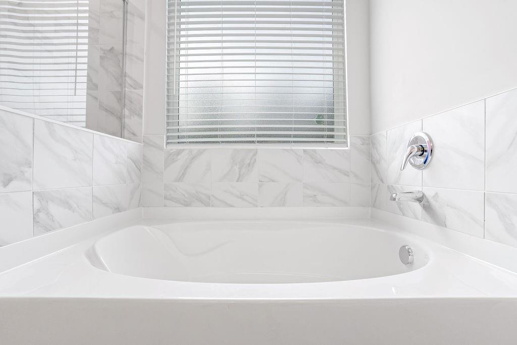 70 Cooper Drive Mansfield, GA 30055 - Photo 19 of 32 a white bath tub sitting next to a window