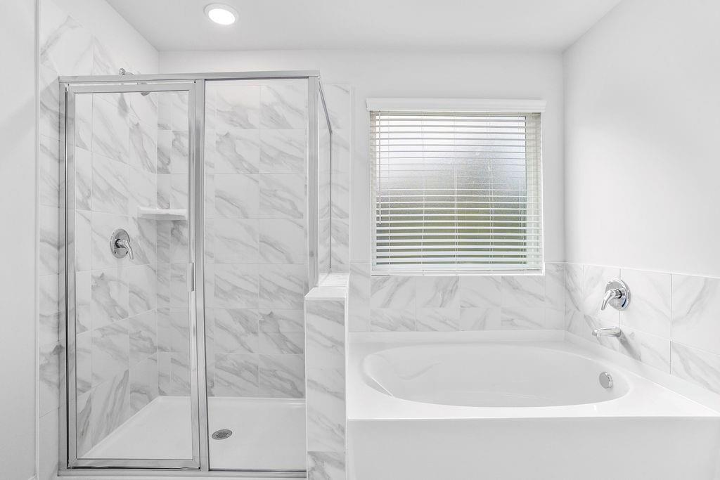 70 Cooper Drive Mansfield, GA 30055 - Photo 20 of 32 a bathroom with a bathtub and a shower