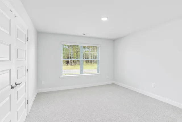 an empty room with closet area