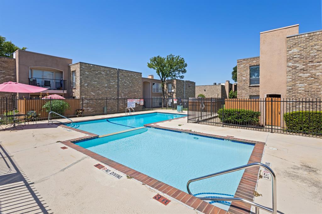 5634 Boca Raton Boulevard, Unit 209 Fort Worth, TX 76112 - Photo 4 of 24 a view of a patio with a table and chairs under an umbrella