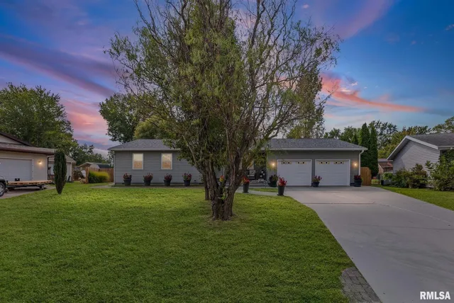 a house view with a sitting space and garden