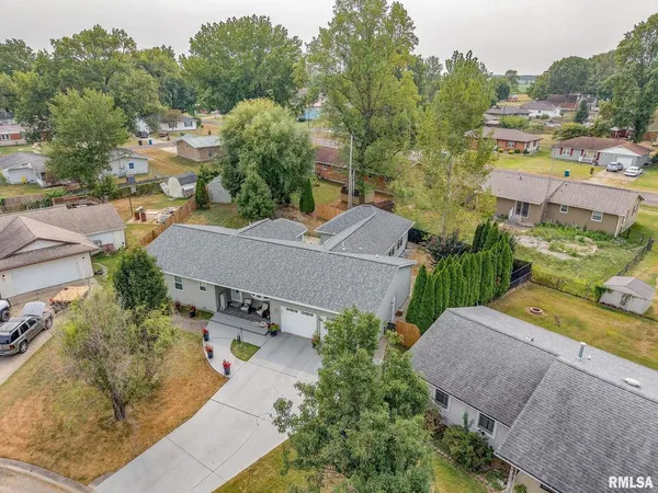 an aerial view of residential houses with outdoor space and street view