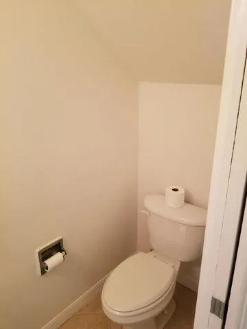 a white toilet sitting next to a bathroom sink