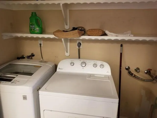 a view of a hallway with wooden floor and furniture