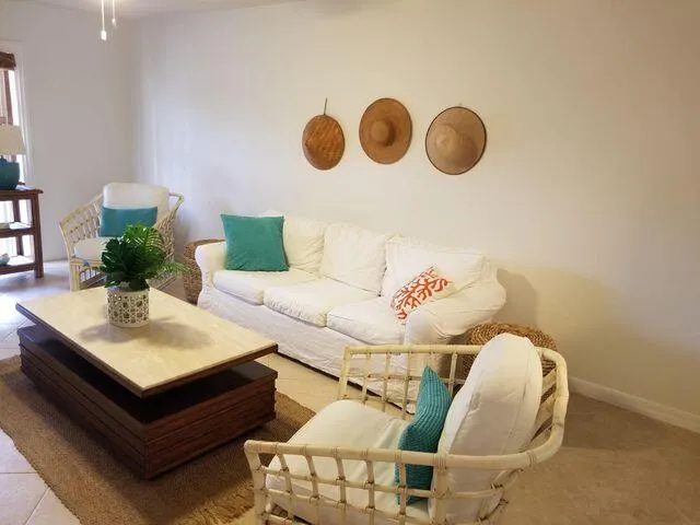 a white toilet sitting next to a white sink and vanity