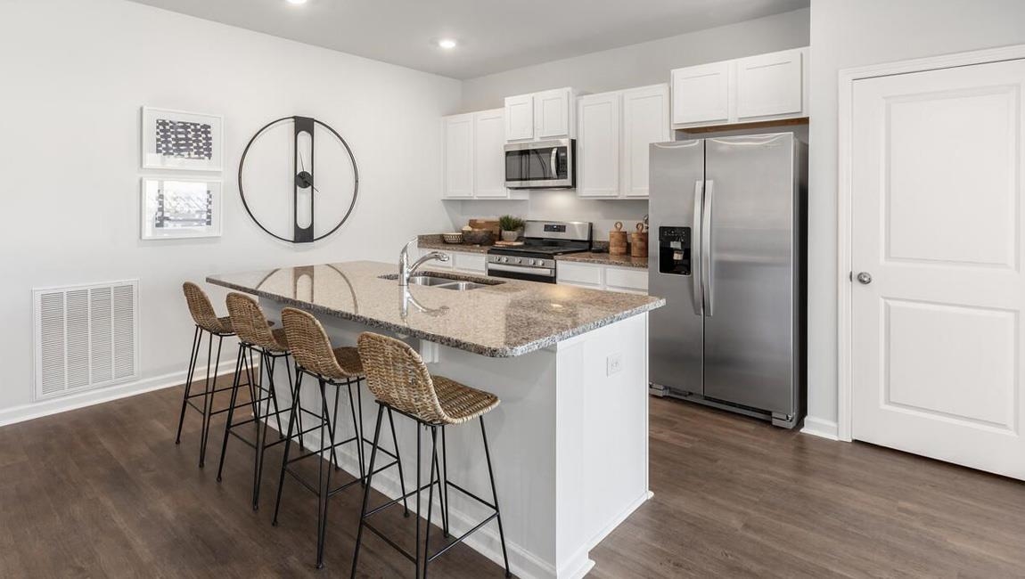 4273 Shelby Road Millington, TN 38053 - Photo 9 of 20 a kitchen with stainless steel appliances granite countertop a refrigerator a stove a sink and a dining table with wooden floor