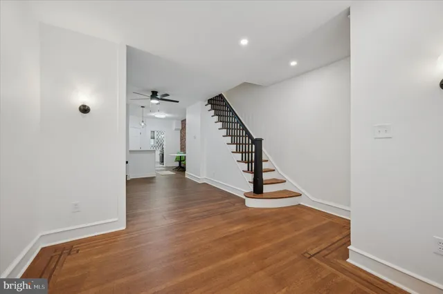 a view of a room with wooden floor and stairs