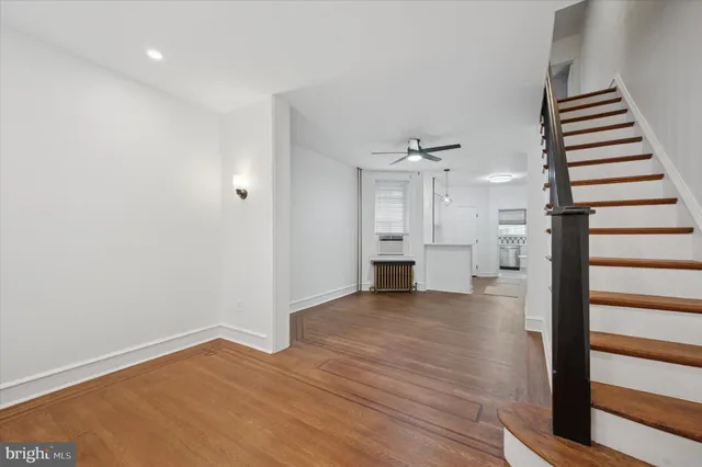 a view of kitchen and hall with wooden floor