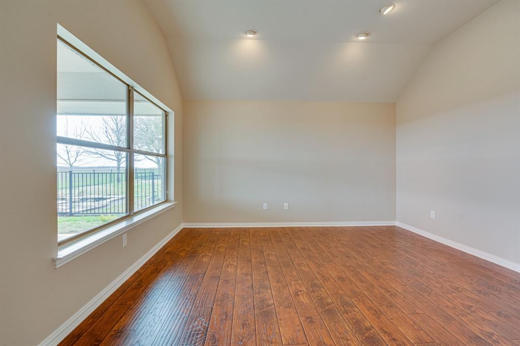 9109 Perimeter Street Denton, TX 76207 - Photo 11 of 27 Unfurnished room featuring vaulted ceiling, dark wood-style floors, and recessed lighting