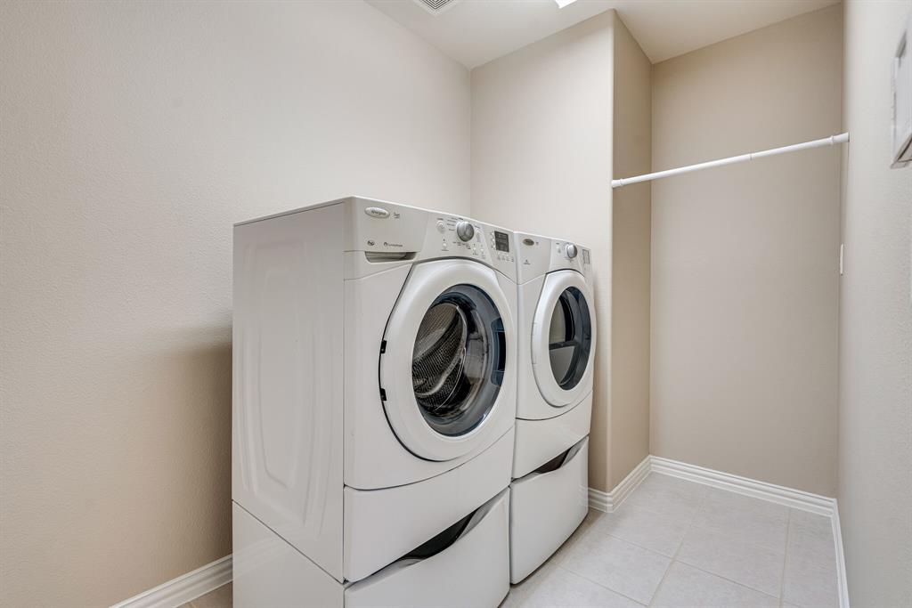 9109 Perimeter Street Denton, TX 76207 - Photo 17 of 27 Laundry room with washer and dryer and light tile patterned floors