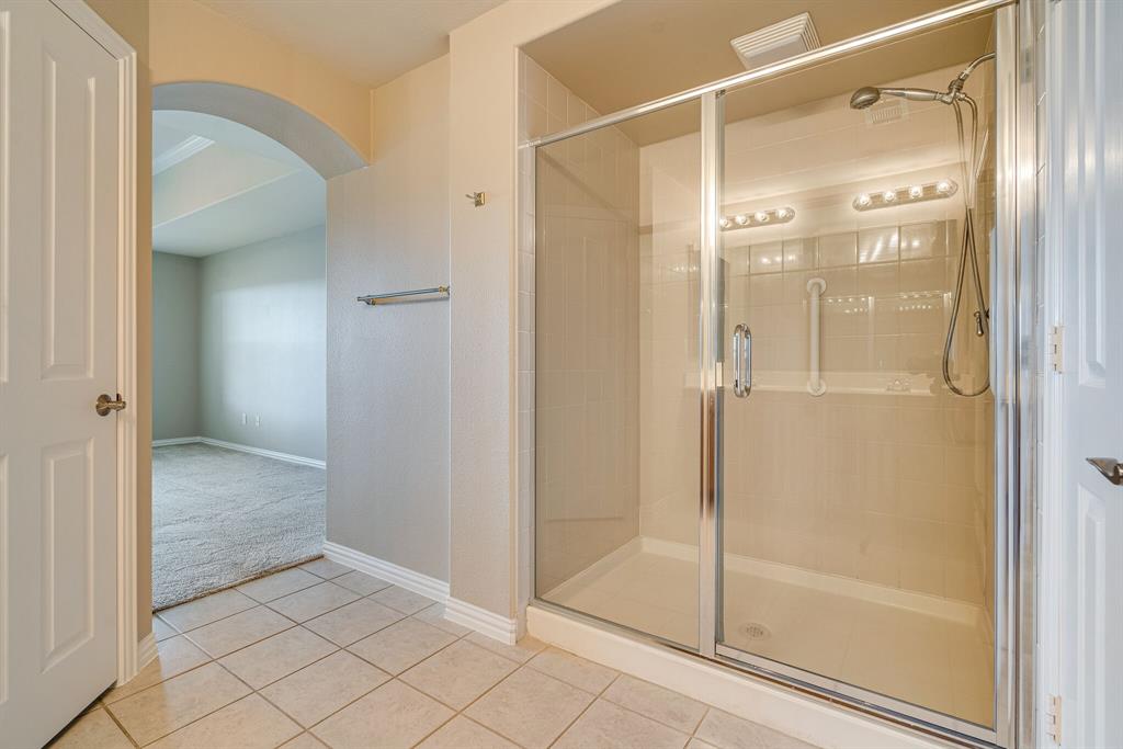 9109 Perimeter Street Denton, TX 76207 - Photo 21 of 27 Bathroom featuring a shower stall, tile patterned flooring, and carpet floors