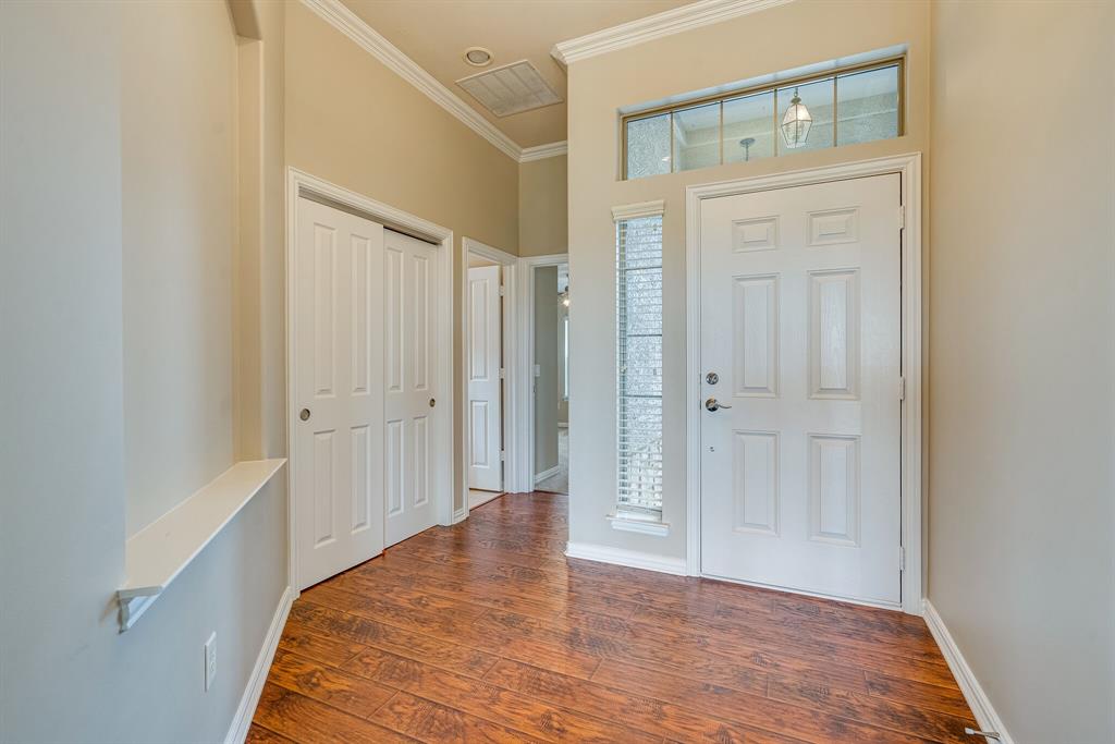 9109 Perimeter Street Denton, TX 76207 - Photo 4 of 27 Entryway featuring crown molding and dark wood-style floors