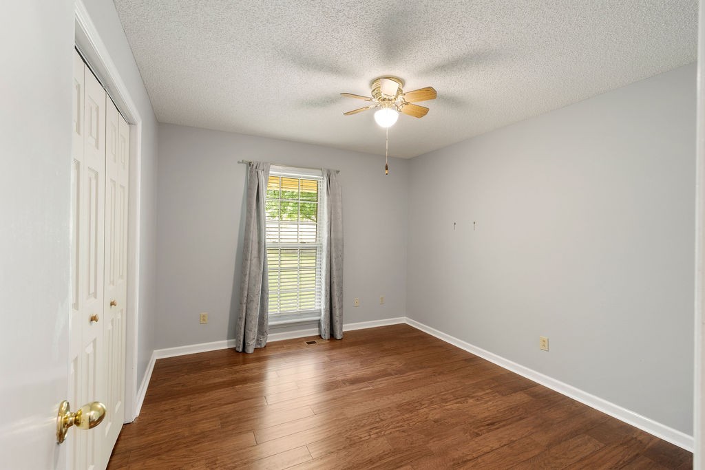 1684 Springplace Road Lewisburg, TN 37091 - Photo 11 of 31 an empty room with wooden floor and windows