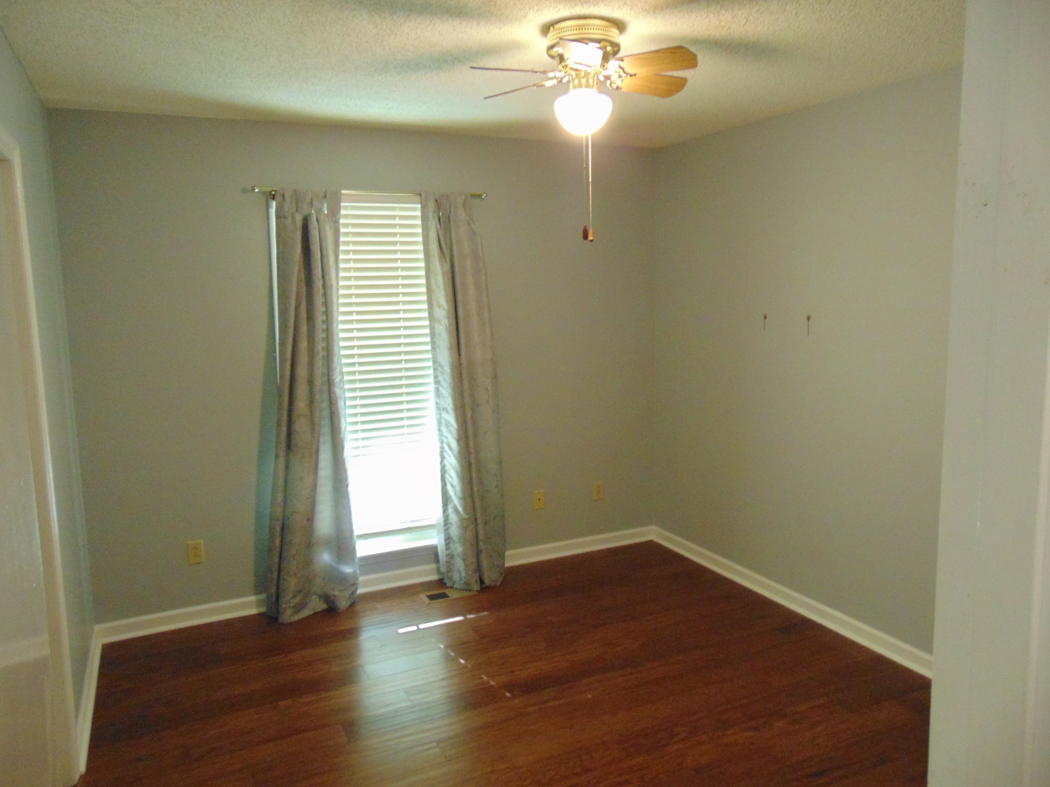 1684 Springplace Road Lewisburg, TN 37091 - Photo 11 of 48 an empty room with wooden floor and windows