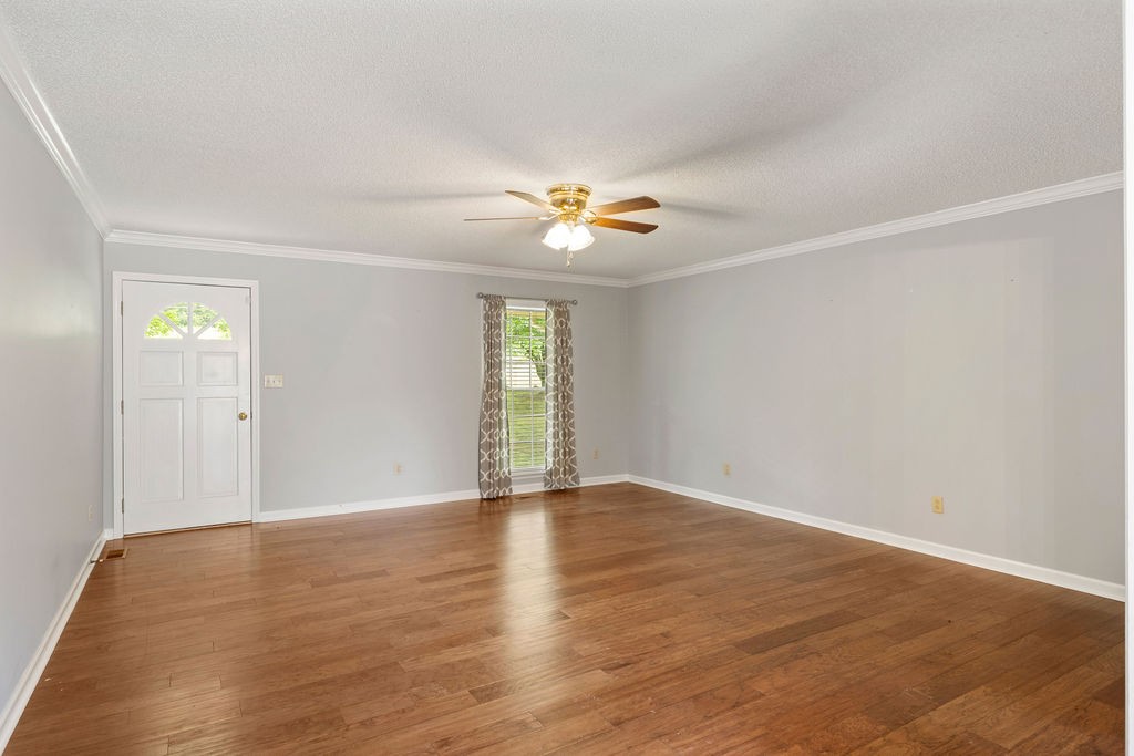 1684 Springplace Road Lewisburg, TN 37091 - Photo 2 of 31 an empty room with window and wooden floor
