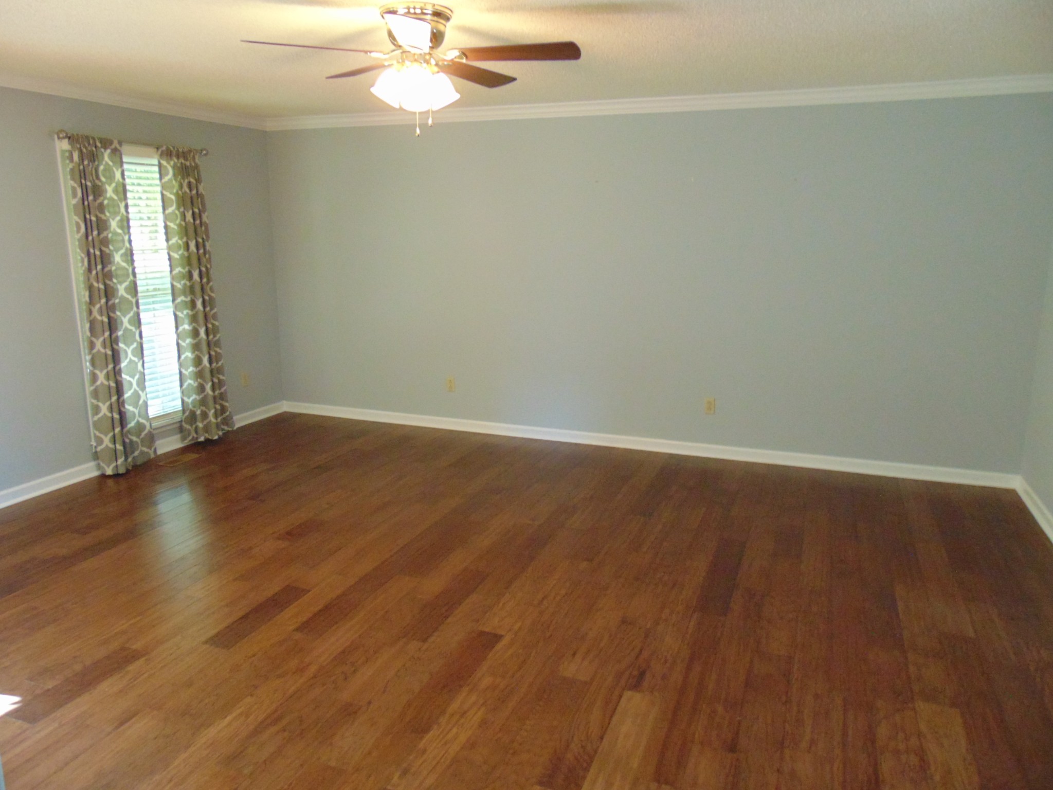 1684 Springplace Road Lewisburg, TN 37091 - Photo 3 of 48 an empty room with wooden floor fan and windows