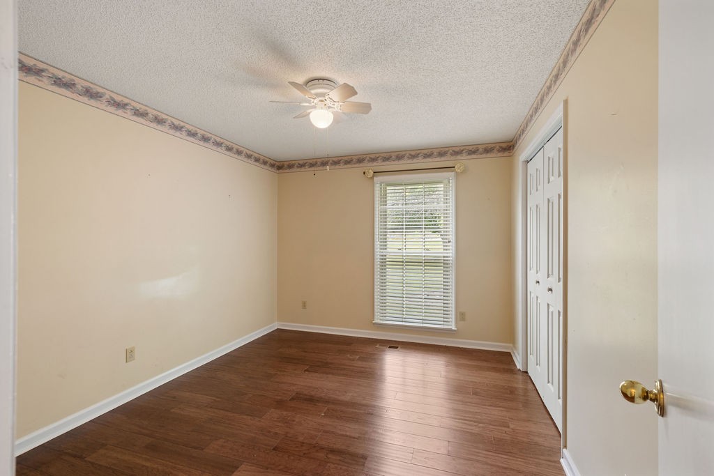1684 Springplace Road Lewisburg, TN 37091 - Photo 9 of 31 a view of an empty room with wooden floor and a window