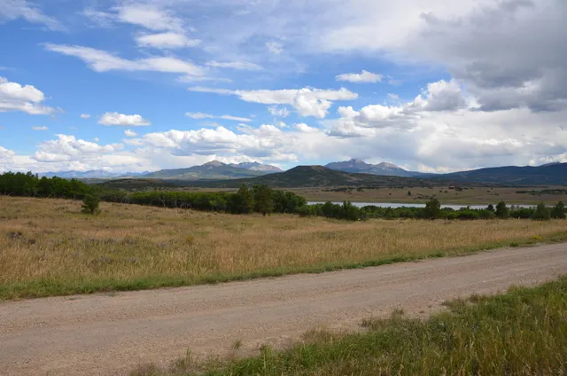 a view of a lake with houses in the back