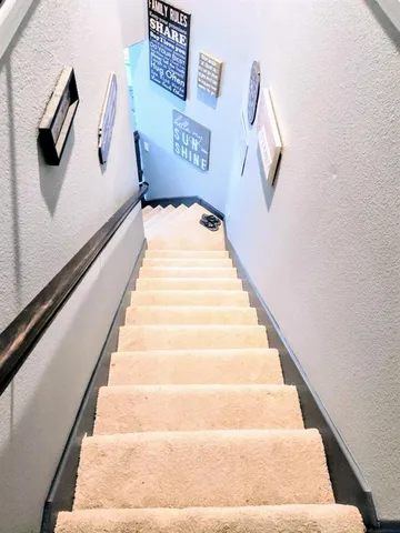 a view of staircase with white walls
