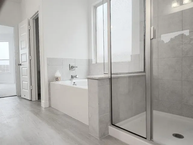 a bathroom with a bathtub and a shower