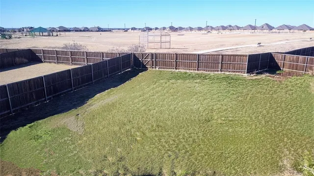 an aerial view of a house a yard and a lake view