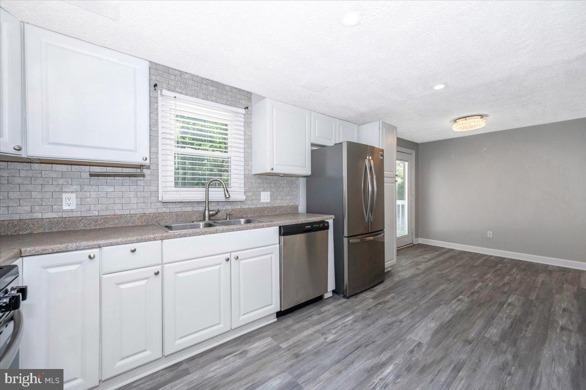 12284 Bandera Lane Lusby, MD 20657 - Photo 17 of 55 a kitchen with a sink wooden floor and stainless steel appliances