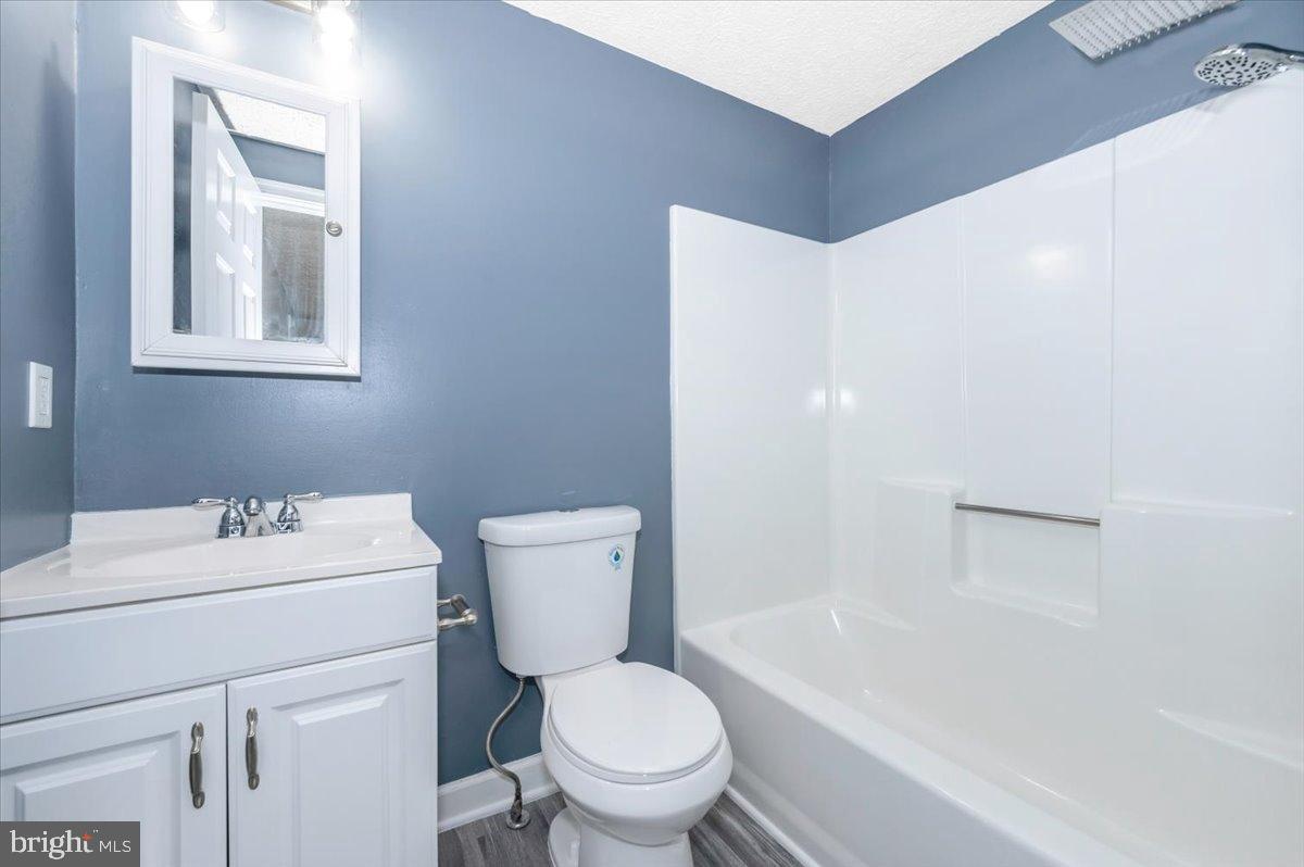 12284 Bandera Lane Lusby, MD 20657 - Photo 23 of 55 a bathroom with a sink toilet vanity and tub