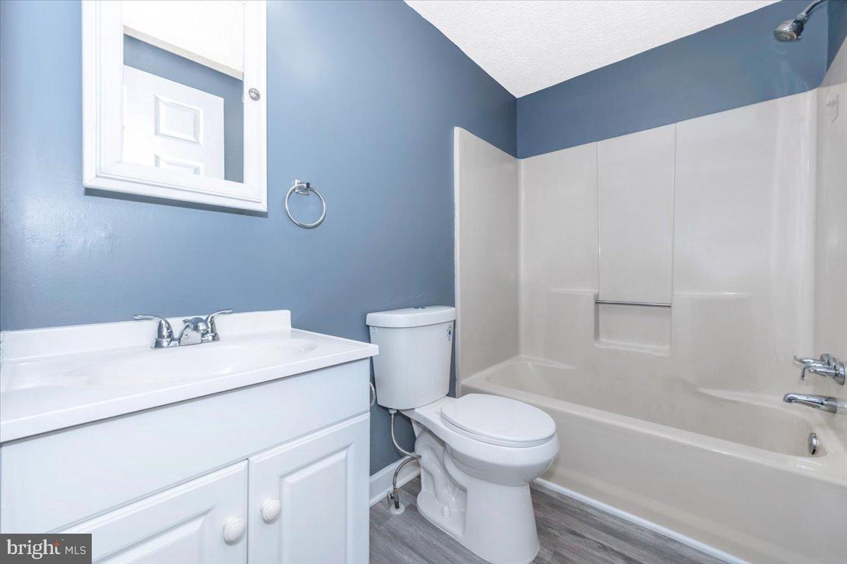 12284 Bandera Lane Lusby, MD 20657 - Photo 28 of 55 a bathroom with a sink toilet vanity and bathtub