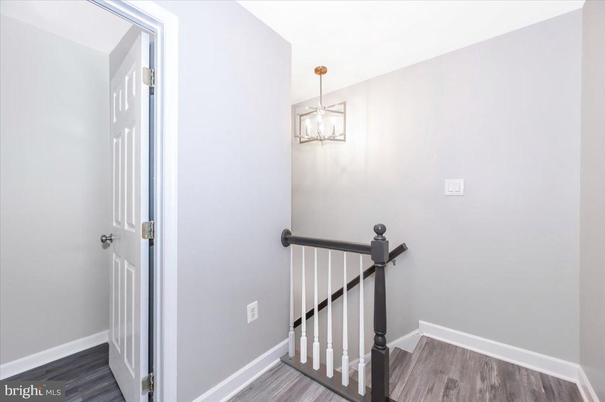 12284 Bandera Lane Lusby, MD 20657 - Photo 29 of 55 a view of a hallway with wooden floor and staircase