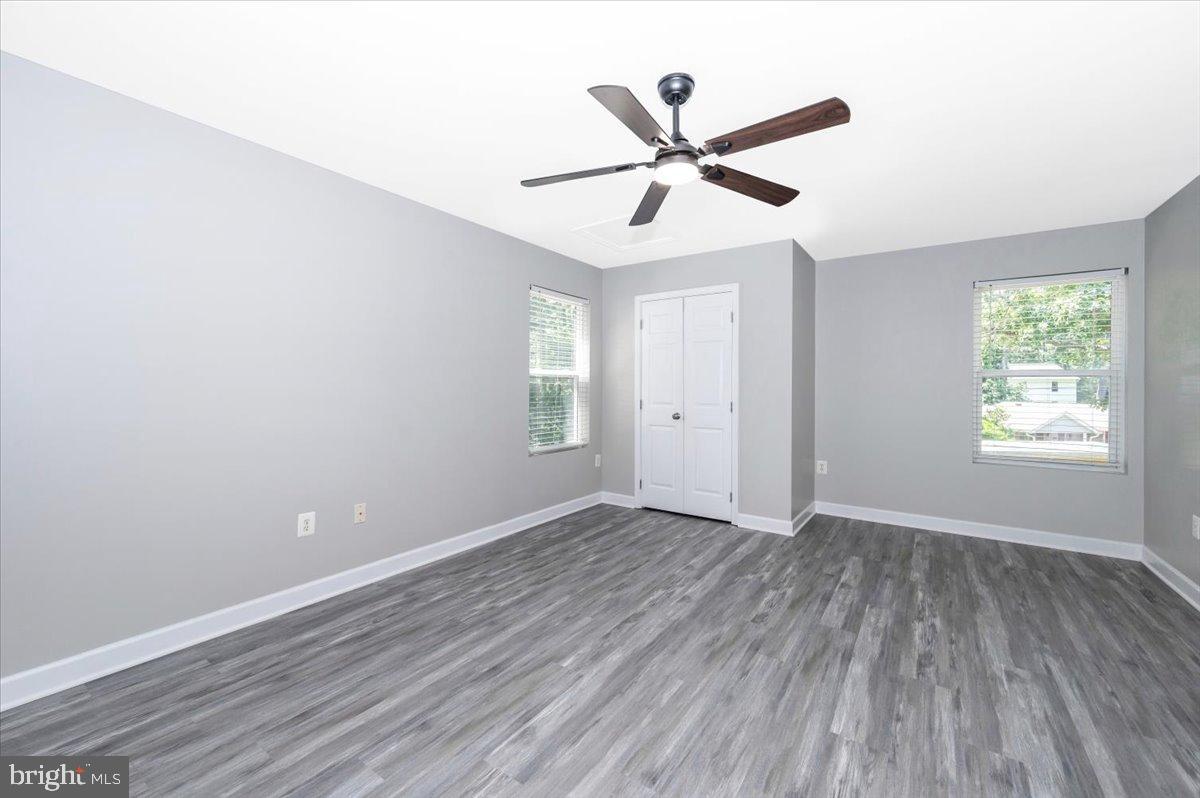 12284 Bandera Lane Lusby, MD 20657 - Photo 30 of 55 a view of a big room with wooden floor closet and windows