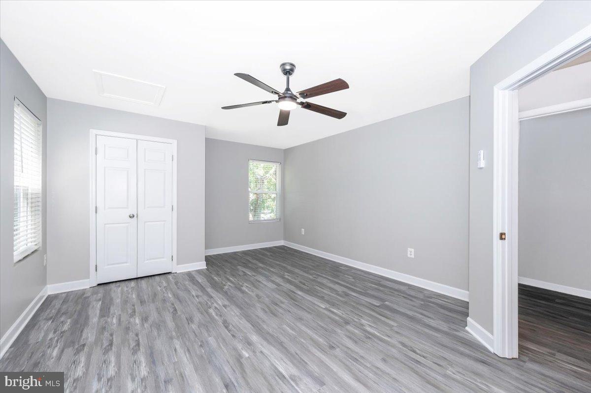 12284 Bandera Lane Lusby, MD 20657 - Photo 32 of 55 an empty room with wooden floor and windows