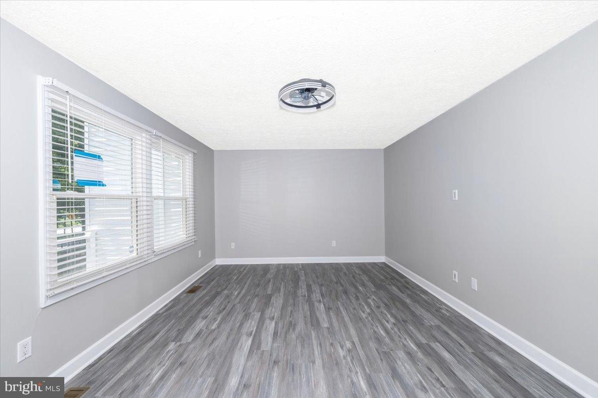 12284 Bandera Lane Lusby, MD 20657 - Photo 4 of 55 a view of a room with wooden floor and window