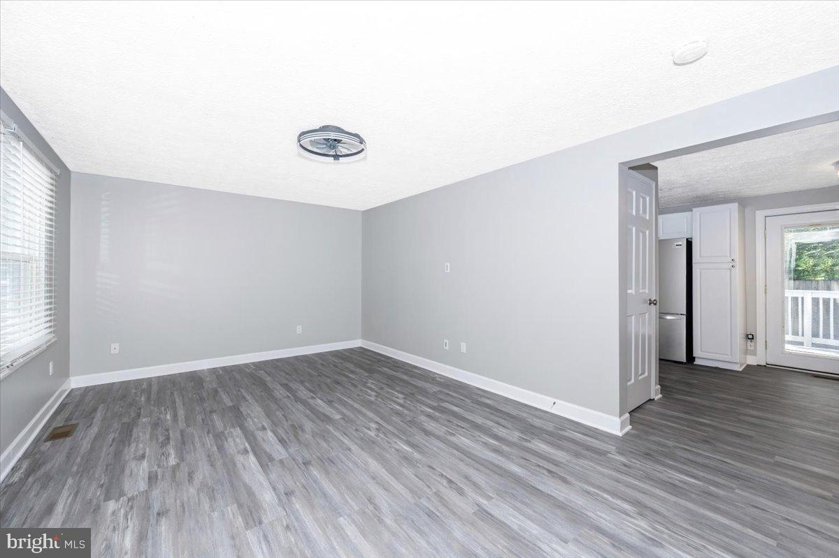 12284 Bandera Lane Lusby, MD 20657 - Photo 5 of 55 an empty room with wooden floor and windows