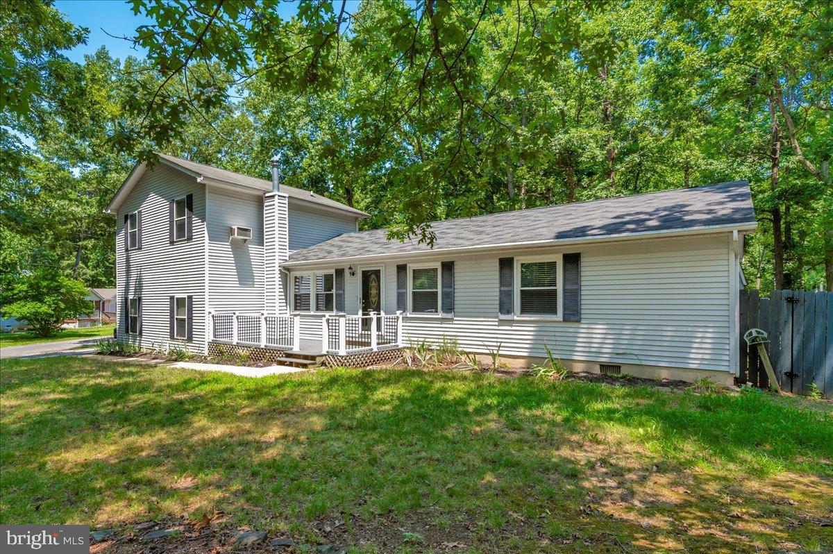 12284 Bandera Lane Lusby, MD 20657 - Photo 52 of 55 a front view of house with yard and green space