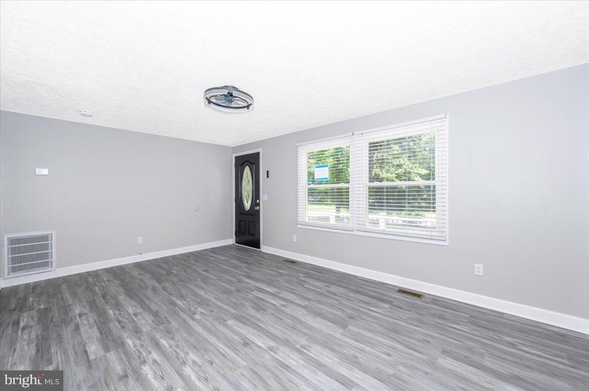 12284 Bandera Lane Lusby, MD 20657 - Photo 6 of 55 an empty room with wooden floor and windows