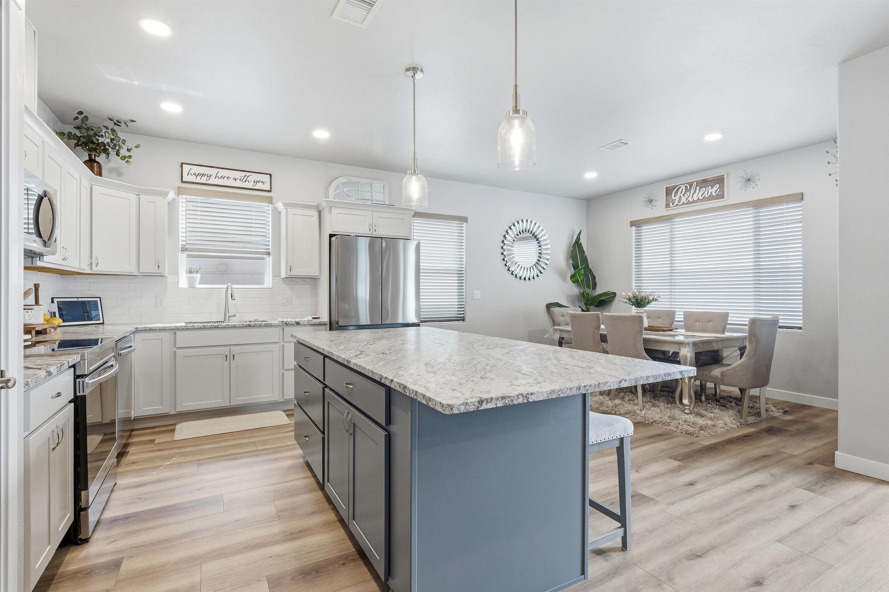 2459 Hamilton Road, Unit A Grand Junction, CO 81505 - Photo 7 of 27 a open kitchen with stainless steel appliances granite countertop a kitchen island a stove and a sink