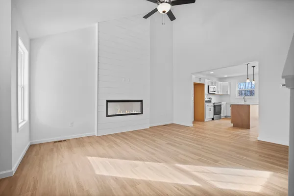 a view of empty room with wooden floor