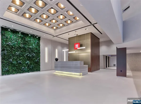 a view of an empty room with a fireplace and a window