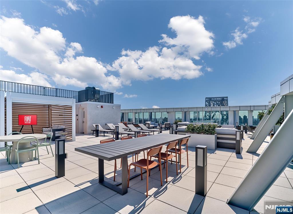 2100 Central Road, Unit 706B Fort Lee, NJ 07024 - Photo 11 of 19 a roof deck with dining table and chairs