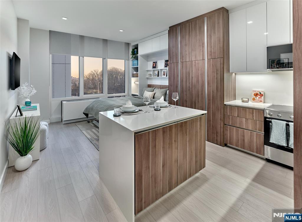 2100 Central Road, Unit 706B Fort Lee, NJ 07024 - Photo 15 of 19 a kitchen with stainless steel appliances granite countertop a sink stove and refrigerator