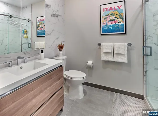a bathroom with a toilet a sink and mirror