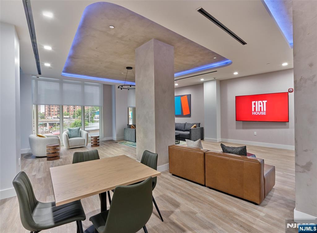 2100 Central Road, Unit 706B Fort Lee, NJ 07024 - Photo 5 of 19 a living room with furniture a large window and a flat screen tv