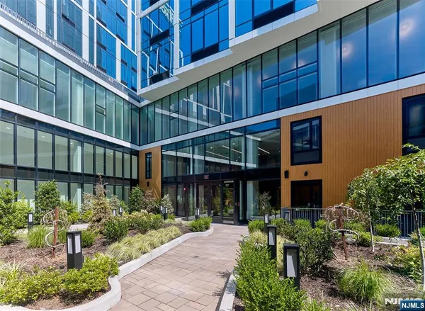 a front view of a building with a garden