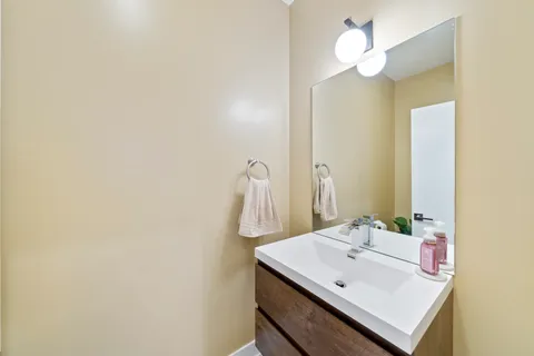 a bathroom with a sink a mirror and a light fixture
