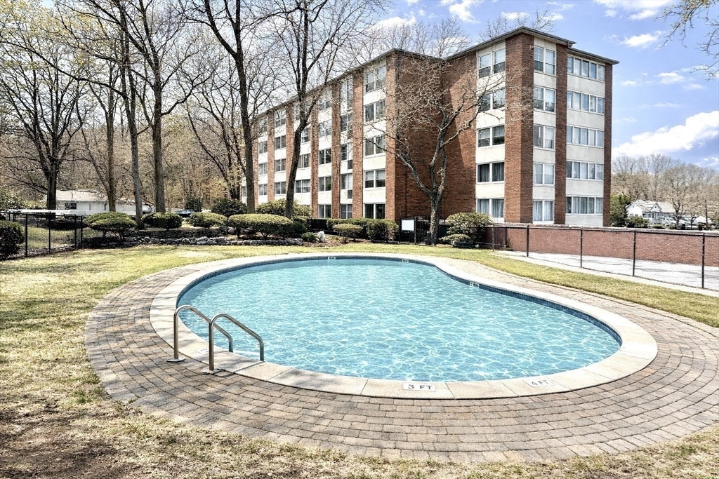 22 Chestnut Place, Unit 210 Brookline, MA 02445 - Photo 16 of 16 a view of swimming pool with outdoor seating and large trees